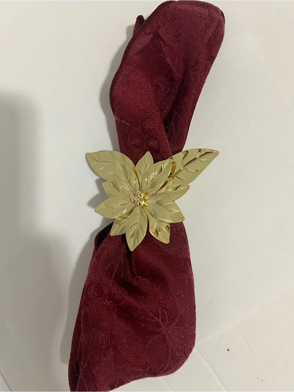 Pre-owned, barely used, gold-tone Poinsettia Napkin Rings -Set of 7